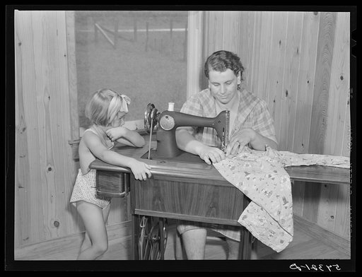 One of the project women making clothes for her family on her new sewing machine. Terrebonne Project. Schriever, Louisiana