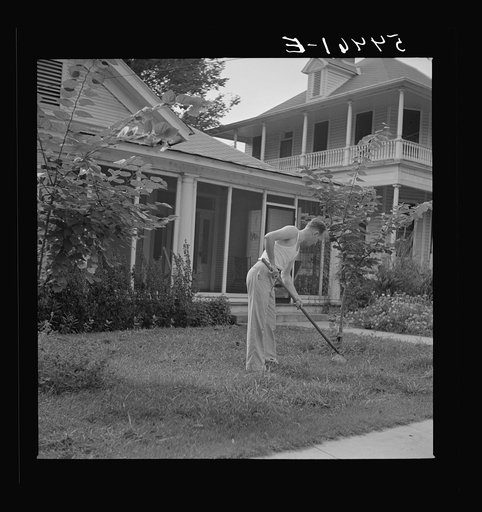 Untitled photo, possibly related to: Man in front of his home weeding his lawn on Sunday. Natchitoches, Louisiana