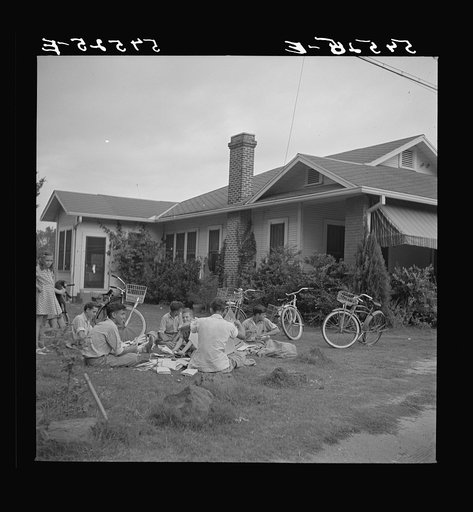Untitled photo, possibly related to: Boys in Natchitoches, Louisiana, folding papers before delivering them in the afternoon
