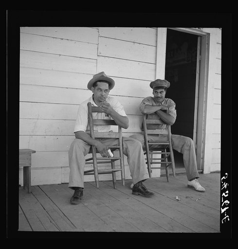 Melrose, Natchitoches Parish, Louisiana. Mulattoes sitting on the porch of country store and barn near John Henry cotton plantation