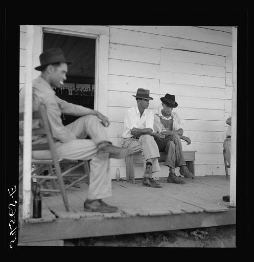Untitled photo, possibly related to: Melrose, Natchitoches Parish, Louisiana. Mulattoes sitting on the porch of country store and bar near John Henry cotton plantation