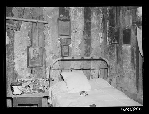 Melrose, Natchitoches Parish, Louisiana. Bedroom with religious pictures, etc. on mud walls of old hut built and still occupied by French mulattoes, near John Henry cotton plantation. Belongs to Rocque family (see general caption)