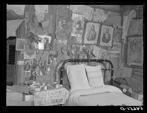 Melrose, Natchitoches Parish, Louisiana. Bedroom with religious pictures, etc. on mud walls of old hut built and still occupied by French mulattoes, near John Henry cotton plantation. Belongs to Rocque family (see general caption)