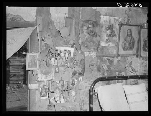 Melrose, Natchitoches Parish, Louisiana. Bedroom with religious pictures, etc. on mud walls of hut built and still occupied by French-mulattoes near John Henry cotton plantation. Belongs to Rocque family (see general caption)