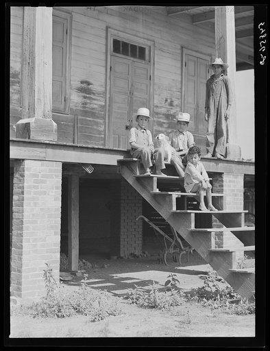 Children of mulatto family sitting on steps of very old home built by some prosperous mulattoes. Melrose, Louisiana
