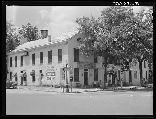Townspeople visiting while sitting in front of Old Talbott Tavern on Saturday afternoon. Bardstown, Kentucky