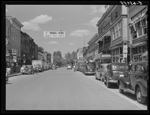 Untitled photo, possibly related to: Center of town with banner advertising church picnic. Bardstown, Kentucky