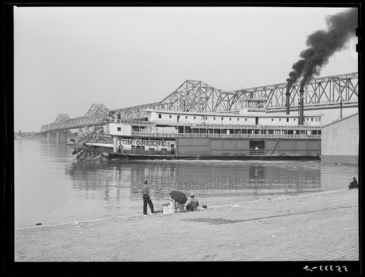 Untitled photo, possibly related to: Riverboat carrying cargo leaving dock along waterfront on Ohio River. Louisville, Kentucky