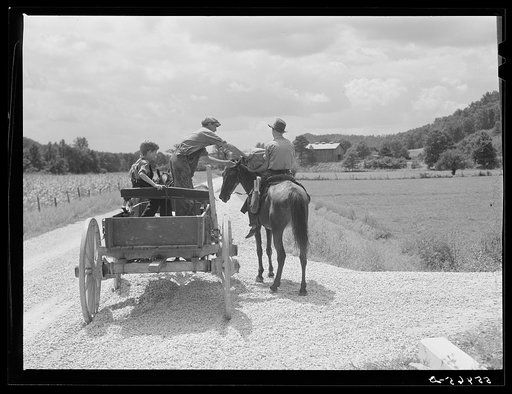 Rural mailman who has brought the mail to the crossroads, transfers letters and packages to another postman's saddlebags. This rider takes the mail further up the side road and creek beds where no wagoon or car can go. In the mountain section near Morehead, Kentucky