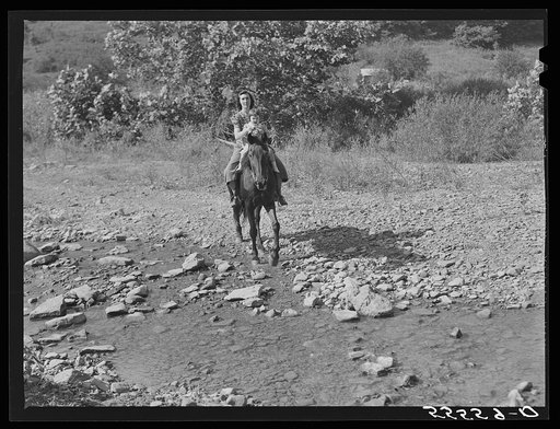 Mountain woman and child travel almost entirely by horseback as the creek beds are still the only roads in some sections. They live up Burton's Fork off Middle Fork of the Kentucky River. Breathitt County, Kentucky