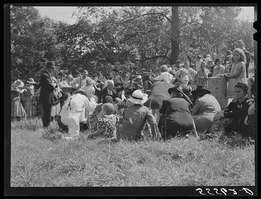 Preacher, friends and relatives of the deceased praying at an annual memorial meeting. Up Frozen Creek, near Jackson, Breathitt County, Kentucky. See general caption number one
