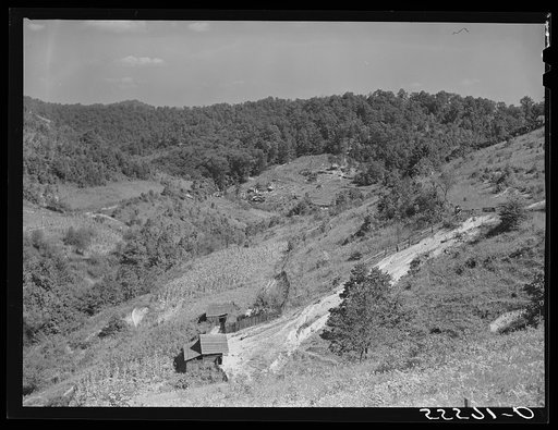 General landscape near Hyden, Kentucky showing mountain cabins, sheds and cornfields