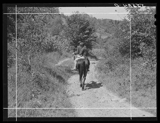 Mountaineer and wife riding home with groceries and supplies. Breathitt County, Kentucky