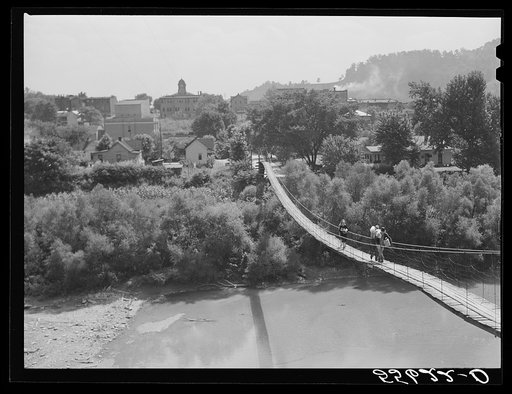Carrying home groceries and supplies across the swinging bridge, Breathitt County, Jackson, Kentucky