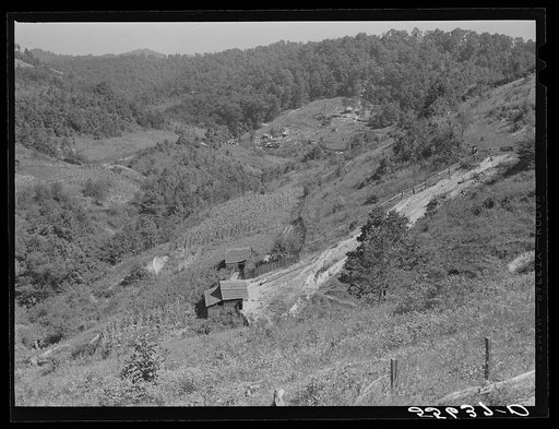 General landscape near Hyden, Kentucky showing mountain cabins, sheds and cornfields
