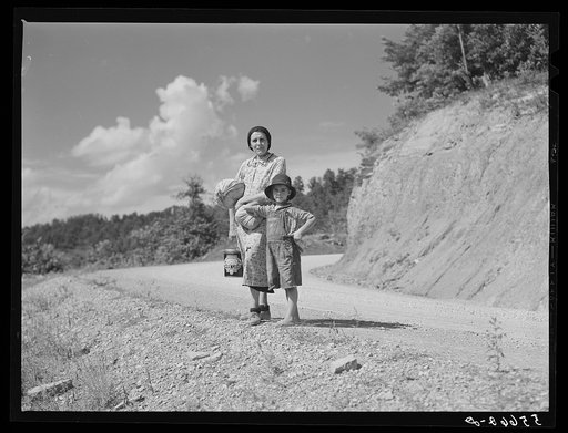 Mountain woman and child going home with groceries and supplies. Breathitt County, Kentucky