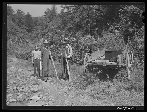 Mountain people getting ready to carry a homemade coffin the rest of the way up the creek bed to the family graveyard where it will be buried. This section is too isolated to have formal funeral services immediately. Up South Fork of the Kentucky River, Kentucky