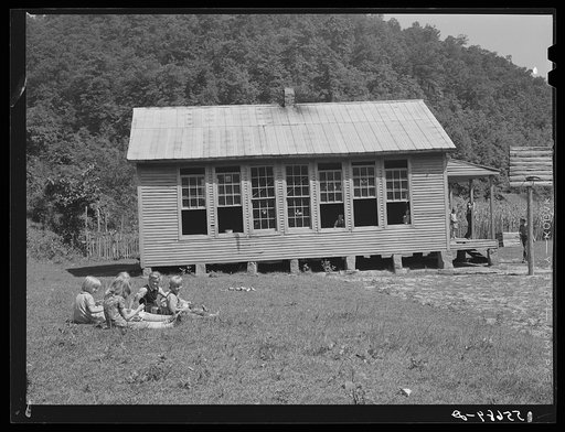 Children eating lunch during noon hour by one-room rural mountain school. Breathitt County, Kentucky
