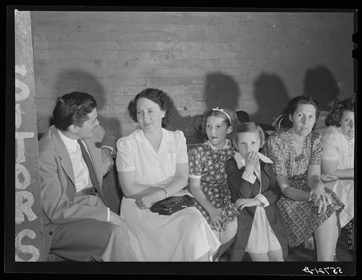 Mrs. Marie R. Turner, and David Donoho at a pie and box supper. Many parents and young people from the school and nearby communities attend the pie and box supper given by the school to raise money for additional repairs and supplies. Each box or pie is auctioned off to the highest bidder, sometimes