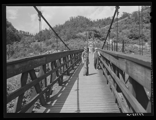 Miners' children crossing swinging bridge from their homes into town. Hazard, Kentucky