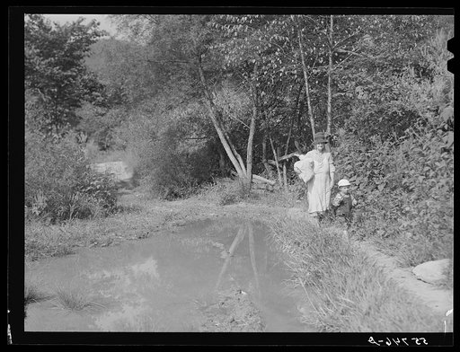 Mountain woman bringing home supplies from the store on Burton's Fork off Middle Fork of the Kentucky River. Breathitt County, Kentucky