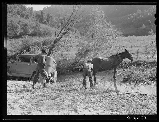 Mountaineers trying to pull the car out of the creek with a mule. South Fork of the Kentucky River. Breathitt County