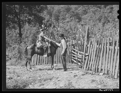 Rural postman delivering mail to a mountaineer who lives up a creek bed where no cars or wagons can pass. Up South Fork of the Kentucky River, near Jackson, Kentucky