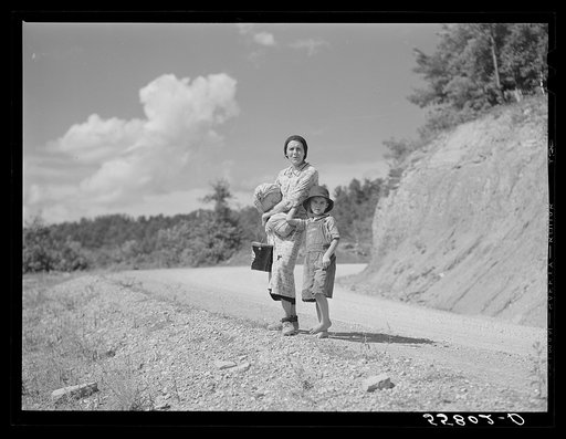 Mountain woman carrying home groceries from the store. Near Hyden, Kentucky