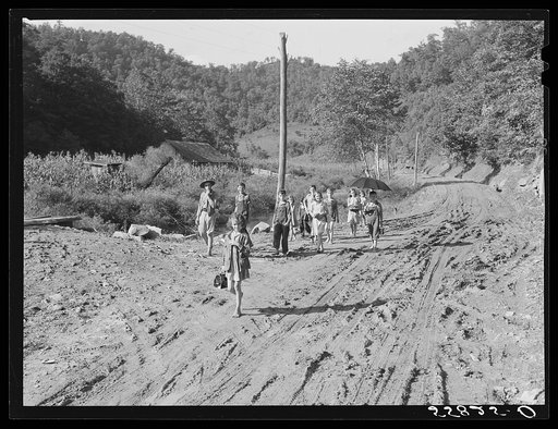 Going home from school in Breathitt County, Kentucky. The school year begins in July and ends in January, as most of the children have no shoes and insufficient clothing to walk the long distances over bad roads and up creek beds