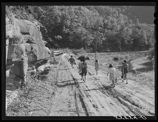 Going home from school iIn Breathitt County, Kentucky. The school year begins in July and ends in January, as most of the children have no shoes and insufficient clothing to walk the long distance over bad roads and up creek beds