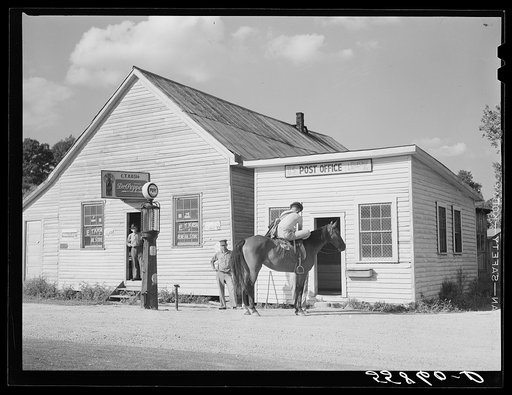 Rural mailman leaving the post office in Landsaw, Kentucky, to take the mail up the paths and creek beds where no cars or wagons can pass