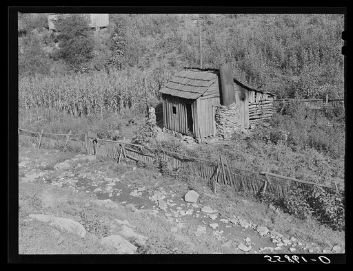 Mountain cabin along creek with corn on the hillside. Near Hyden, Kentucky