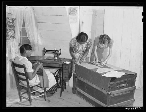 FSA (Farm Security Administration) home supervisor Miss Harton helping one of borrowers' families cut patterns and make their own clothes. Caswell County, North Carolina