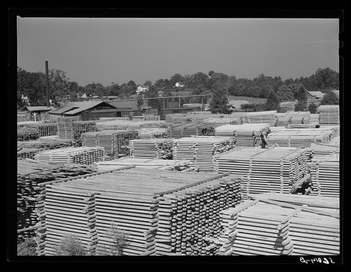 Untitled photo, possibly related to: Stacks of lumber and sawmill. Pittsboro, Chatham County, North Carolina