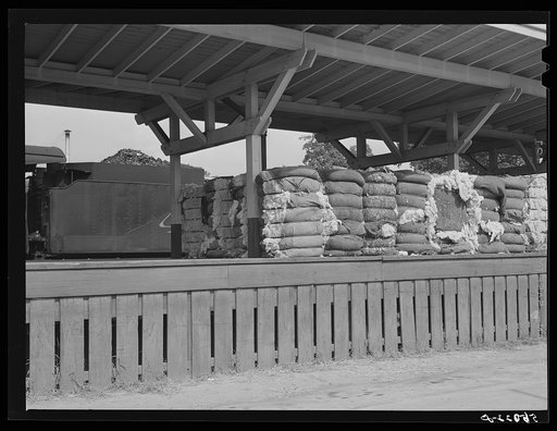 Untitled photo, possibly related to: Railway station with bales of cotton on platform. Mebane, North Carolina