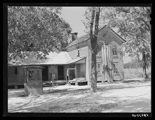 Old house and well about 100 years old, occupied by white farmer. Vertical boarding where chimney formerly was. Farrington, Chatham County, North Carolina