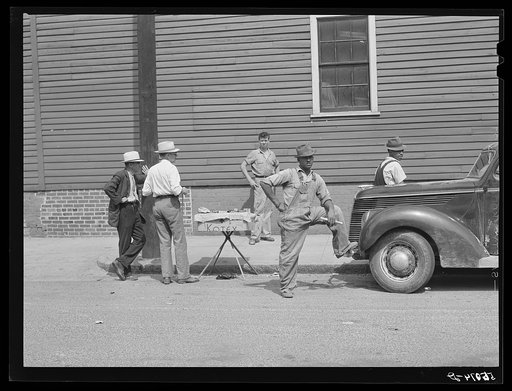Untitled photo, possibly related to: Peddler selling patent medicines to farmers outside warehouse on opening day of tobacco market in Mebane, North Carolina, where many Caswell County farmers sell their tobacco at auction
