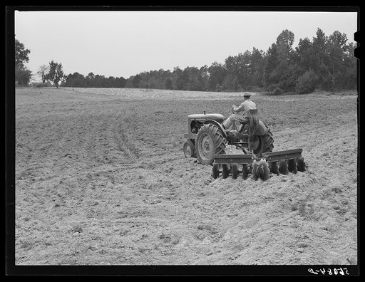 Emery Hooper, discing neighbor's land in preparation for planting fall wheat with equipment purchased with a FSA (Farm Security Administration) co-operative community service loan. Caswell County, North Carolina