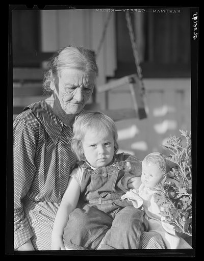 Untitled photo, possibly related to: Mountain woman and grandchild sitting on the porch of their home up Frozen Creek, Breathitt County, Kentucky