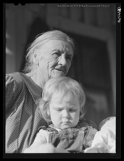 Untitled photo, possibly related to: Mountain woman and grandchild sitting on the porch of their home up Frozen Creek, Breathitt County, Kentucky