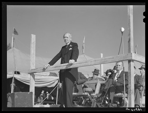 Governor Hoey speaking at Caswell County Fair, with school superintendent Holland McSwain at right on platform. Yanceyville, North Carolina