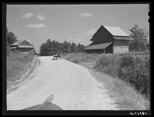 Untitled photo, possibly related to: Wagon with stocks of meal on road in Corbett Ridge section. Caswell County, North Carolina