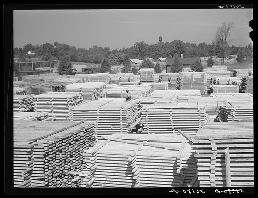 Untitled photo, possibly related to: Stacks of lumber and sawmill. Pittsboro, Chatham County, North Carolina