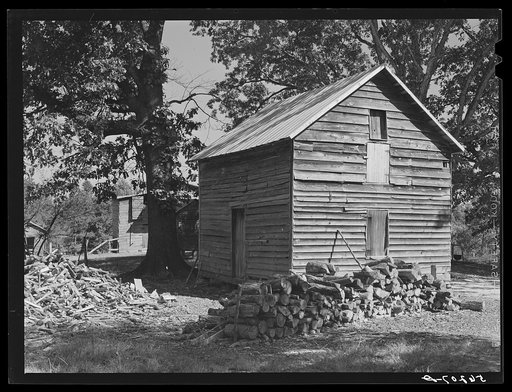 Storing barns and woodpiles on Emery Hooper's farm near Prospect Hill. Caswell County, North Carolina
