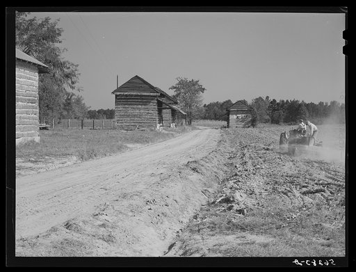 Spreading lime to increase productivity of soil before planting winter wheat on Emery M. Hopper's tobacco farm in Corbett Ridge section. Caswell County, North Carolina