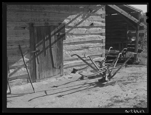 Plows in front of tobacco barn on Emery Hopper's farm in Corbett Ridge section. Caswell County, North Carolina