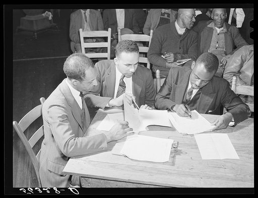 Untitled photo, possibly related to: Working on the county maps at the colored county land use planning committee meeting in the schoolhouse in Yanceyville, Caswell County, North Carolina. William L. Gilmore, teacher in Caswell County training school, is secretary of meeting