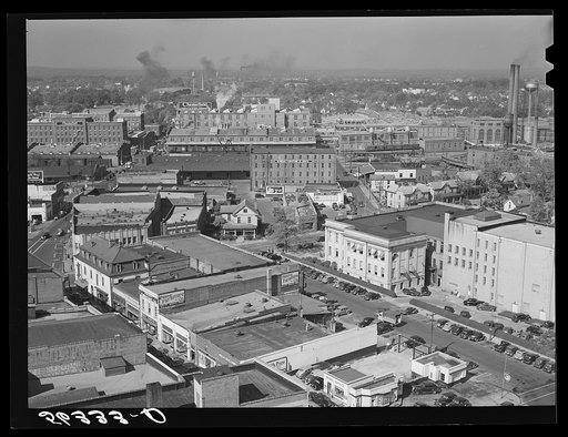 Untitled photo, possibly related to: Five points, center of city, with Chesterfield cigarette factories in background. Durham, North Carolina