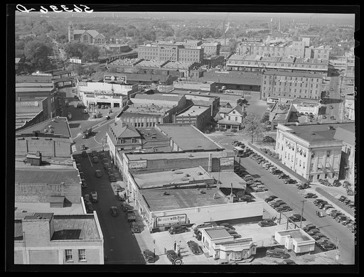 Untitled photo, possibly related to: Five points, center of city, with Chesterfield cigarette factories in background. Durham, North Carolina