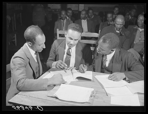 Working on the county maps at the colored county land use planning committee meeting in the schoolhouse in Yanceyville, Caswell County, North Carolina. William L. Gilmore, teacher in Caswell County training school, is secretary of meeting